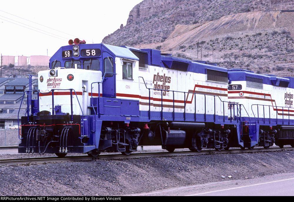 Phelps-Dodge GP38-2's #58, #57 leave shop area in morning. 